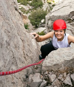 16951143-portrait-of-cheerful-female-climber-ascending-a-rock